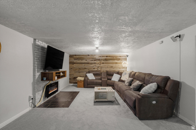 961 33rd Street Ogden, UT 84403 - Photo 20 of 39 Reclaimed wood accent wall, built-in electric fireplace with tile hearth, and suspended media console