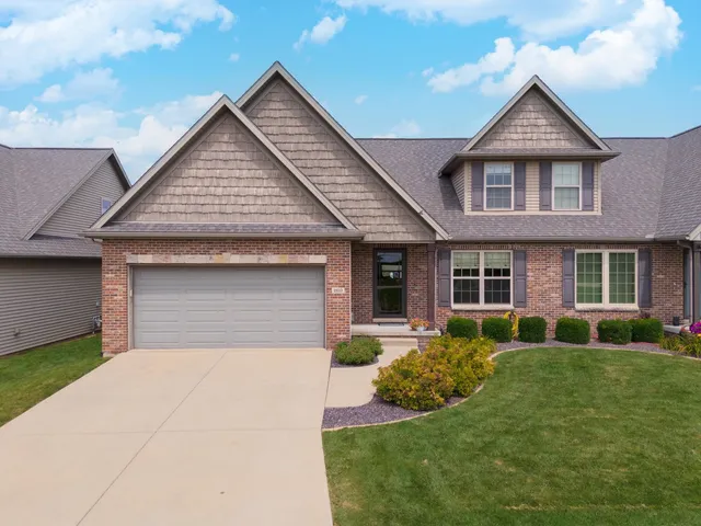 a front view of a house with a yard and porch