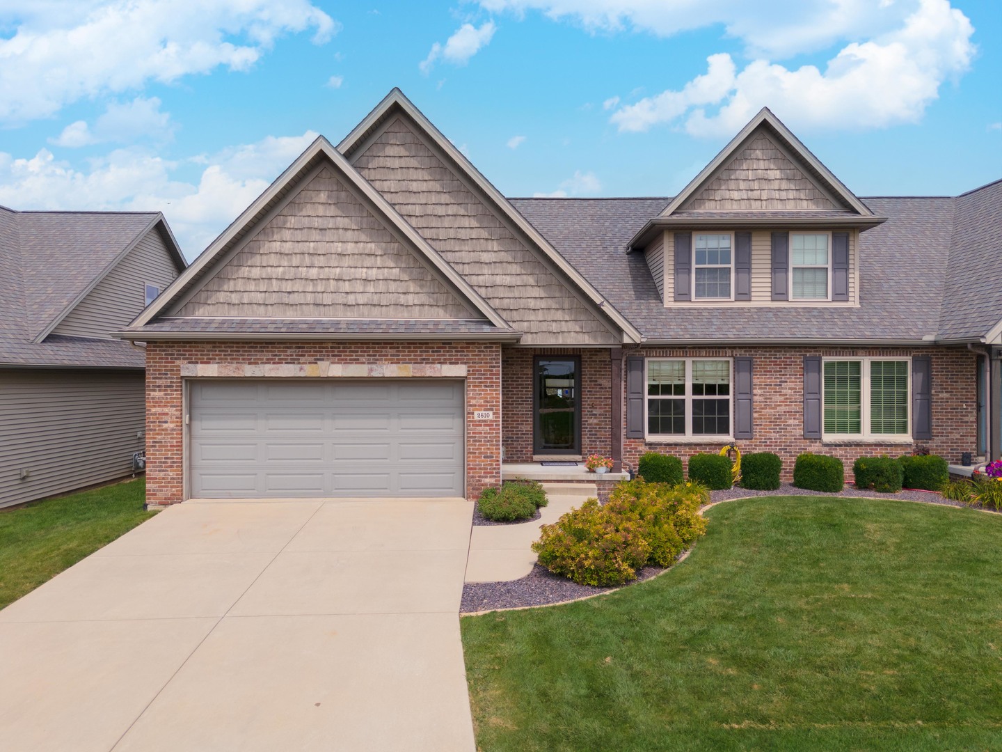 a front view of a house with a yard and porch