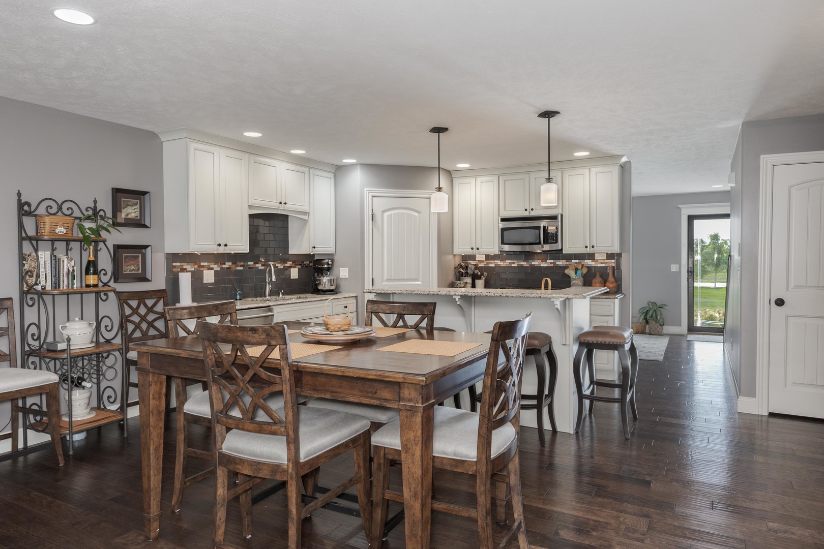 2610 Shepard Road Normal, IL 61761 - Photo 16 of 46 a kitchen with stainless steel appliances granite countertop a stove a refrigerator a kitchen island and chairs with wooden floor