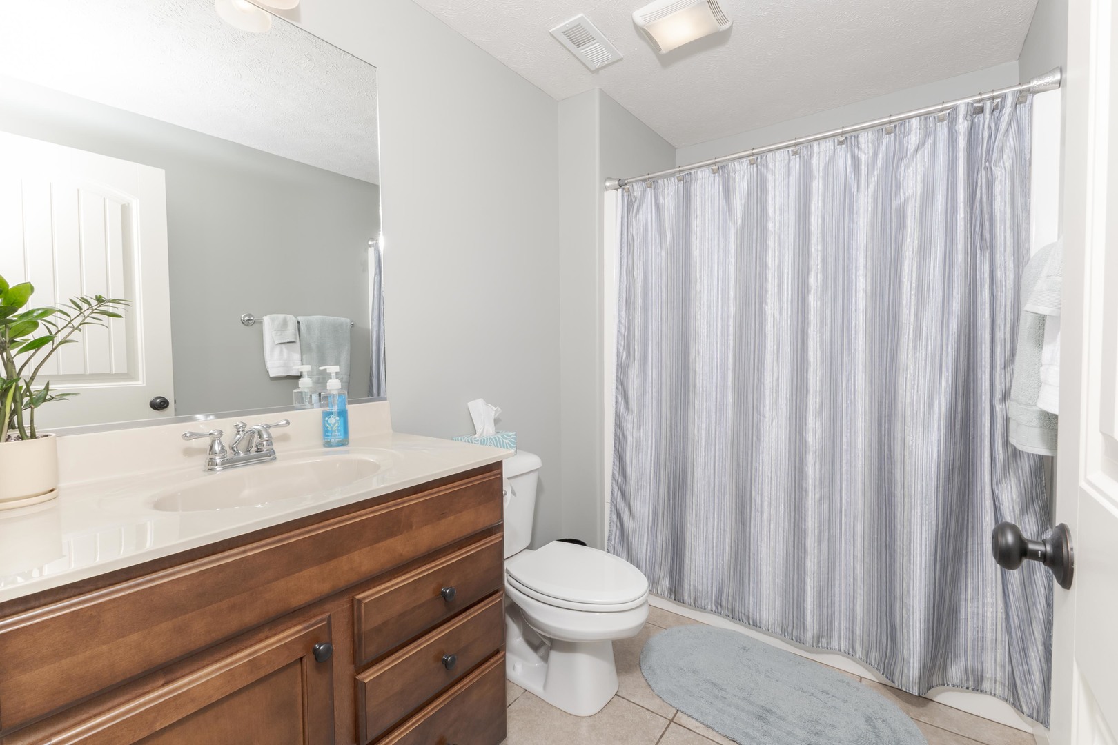 2610 Shepard Road Normal, IL 61761 - Photo 35 of 46 a bathroom with a sink a toilet a mirror and shower curtain