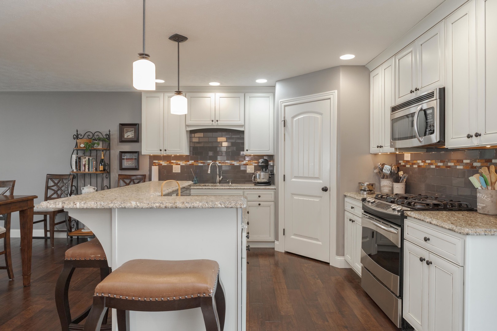 2610 Shepard Road Normal, IL 61761 - Photo 7 of 46 a kitchen with kitchen island granite countertop a stove a sink a refrigerator and white cabinets with wooden floor