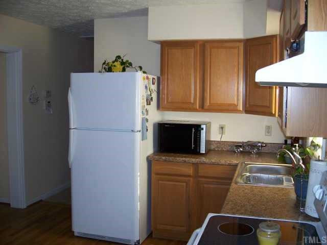 3508 Bahama Road Rougemont, NC 27572 - Photo 4 of 10 a kitchen with a refrigerator and a stove top oven