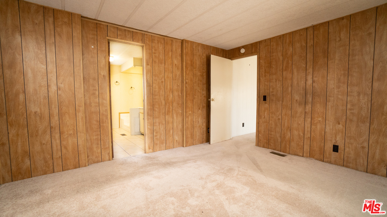17701 South Avalon Boulevard, Unit 147 Carson, CA 90746 - Photo 21 of 28 a view of an empty room and wooden shelves