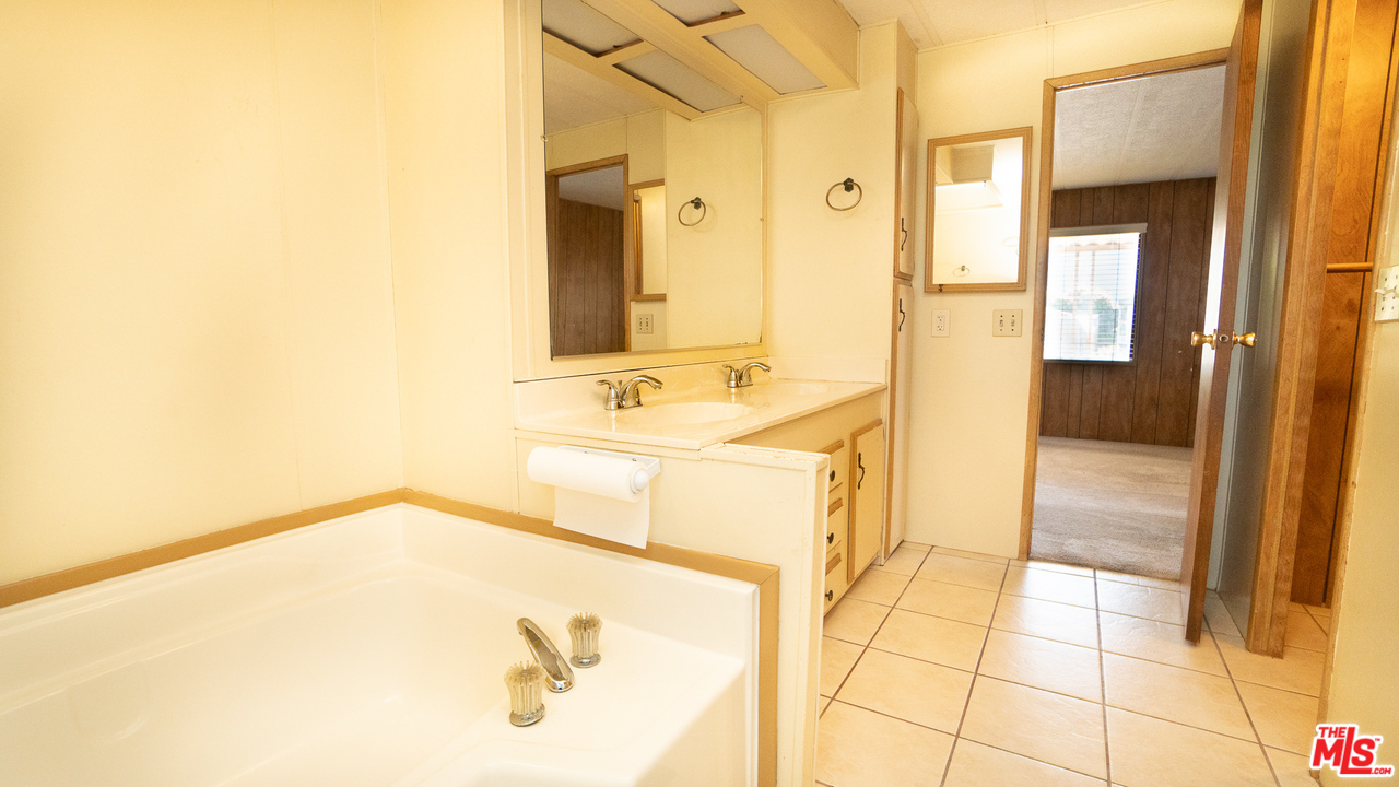 17701 South Avalon Boulevard, Unit 147 Carson, CA 90746 - Photo 23 of 28 a bathroom with a tub sink and mirror