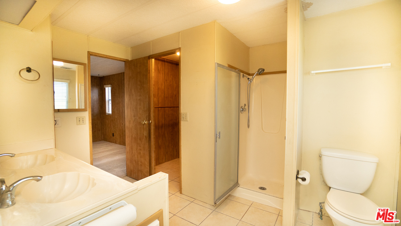 17701 South Avalon Boulevard, Unit 147 Carson, CA 90746 - Photo 24 of 28 a bathroom with a sink and a mirror