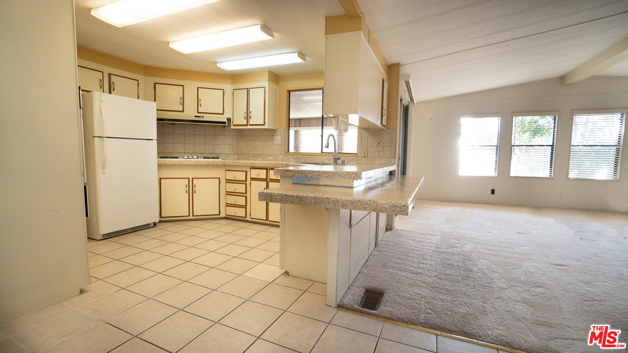 17701 South Avalon Boulevard, Unit 147 Carson, CA 90746 - Photo 7 of 28 a kitchen with stainless steel appliances a stove a sink and a refrigerator