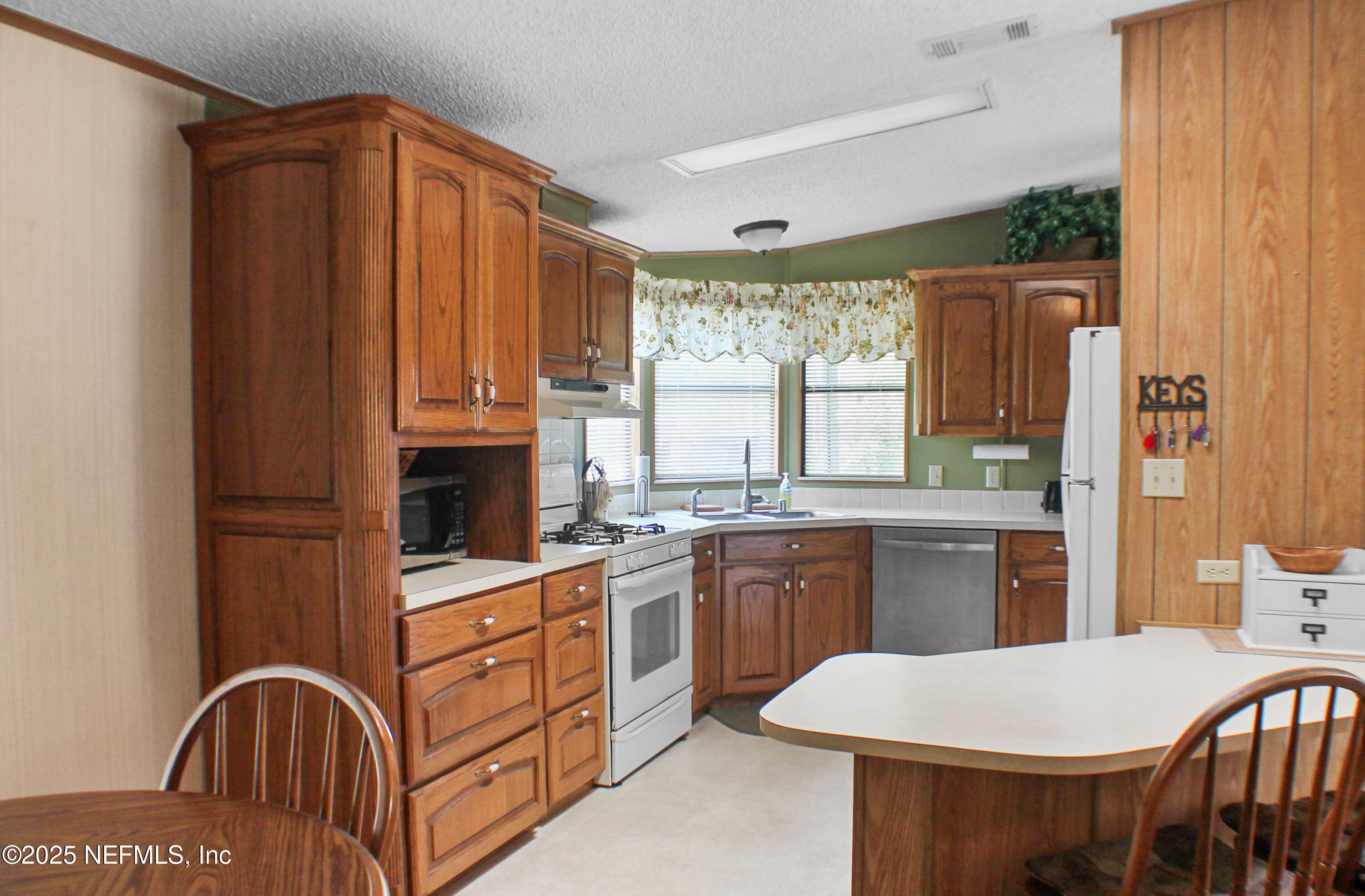 134 Magnolia Street Satsuma, FL 32189 - Photo 11 of 62 a kitchen with stainless steel appliances granite countertop a stove a sink dishwasher and a refrigerator