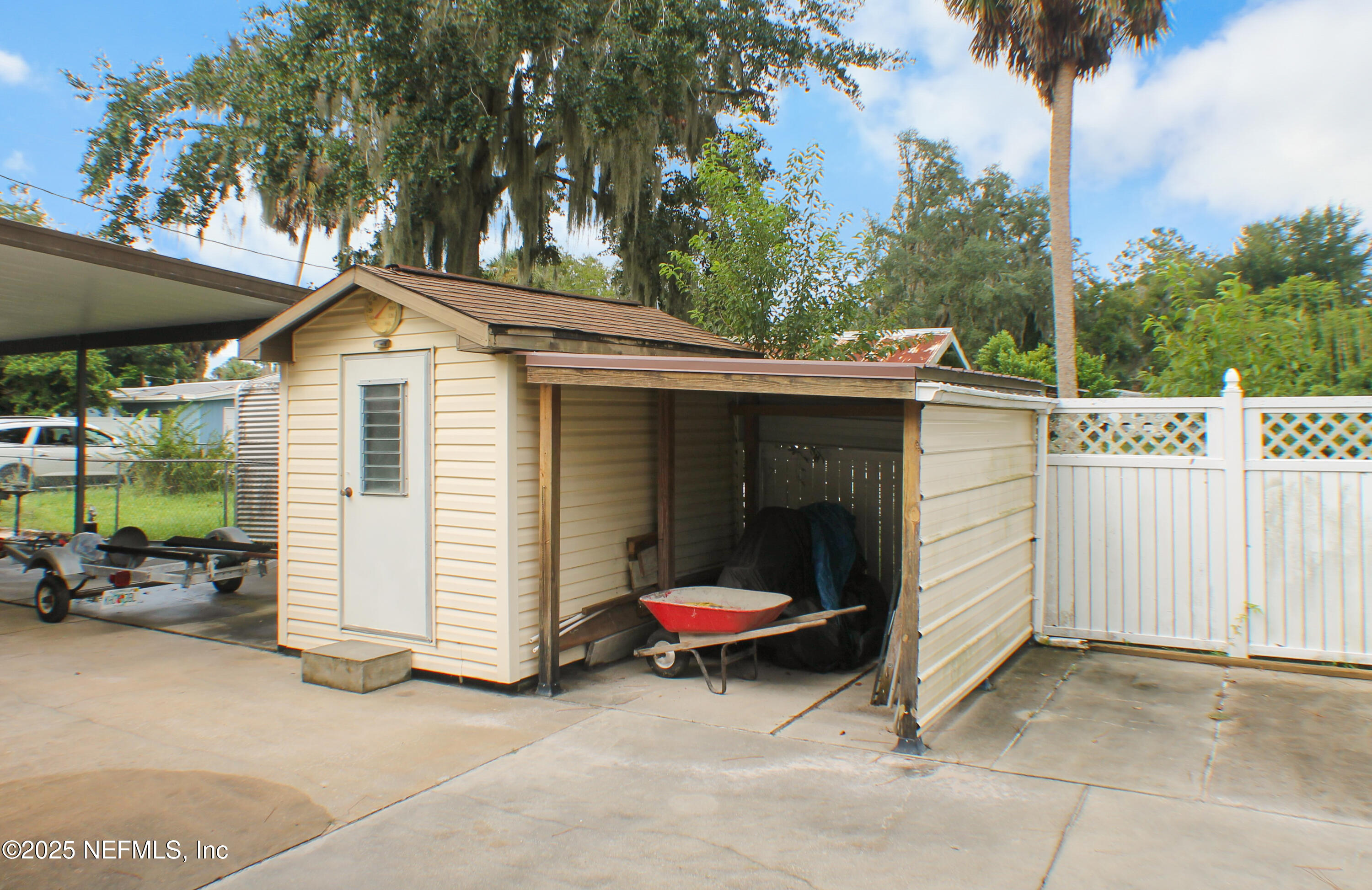 134 Magnolia Street Satsuma, FL 32189 - Photo 22 of 62 a backyard of a house with barbeque oven and outdoor seating