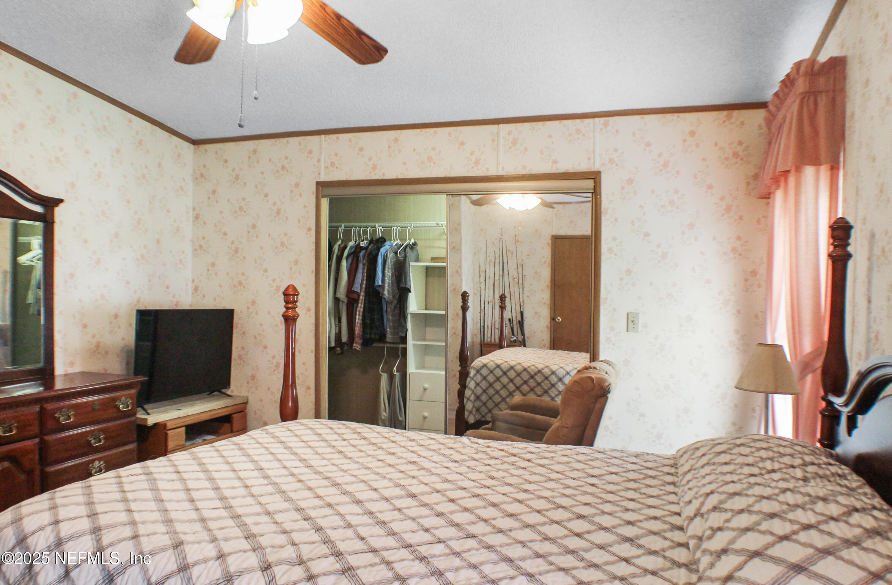 134 Magnolia Street Satsuma, FL 32189 - Photo 27 of 62 a bedroom with a bed and a flat screen tv