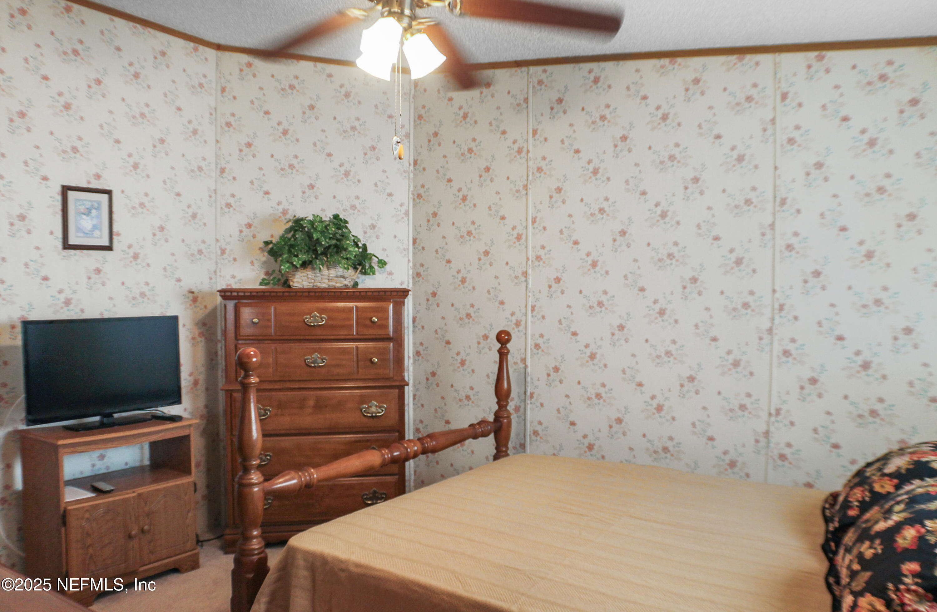134 Magnolia Street Satsuma, FL 32189 - Photo 32 of 62 a bedroom with a bed and flat screen tv