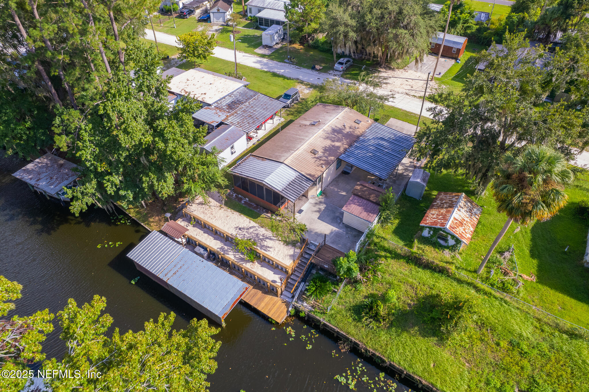 134 Magnolia Street Satsuma, FL 32189 - Photo 46 of 62 an aerial view of a house with a lake view
