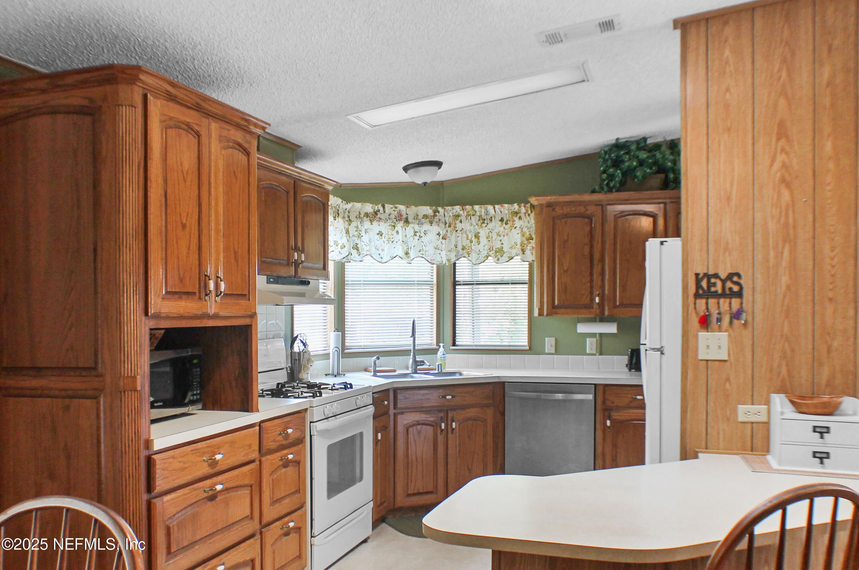 134 Magnolia Street Satsuma, FL 32189 - Photo 9 of 62 a kitchen with a sink a window and cabinets