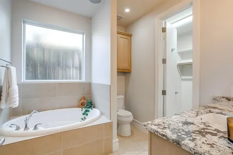 a bathroom with a tub sink and toilet