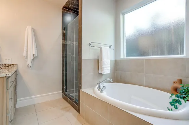 a bathroom with a tub and shower