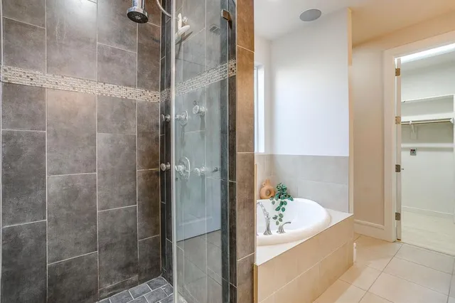 a bathroom with a granite countertop shower a mirror and a sink