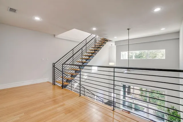 a view of entryway and hall with wooden floor