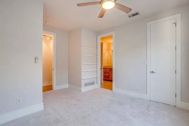 a view of an empty room with a bathroom
