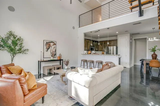 a living room with furniture and a potted plant
