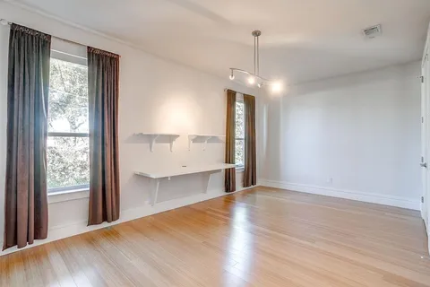 a view of a kitchen with a sink and dishwasher wooden floor