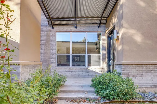 a couple of potted plants in front of door