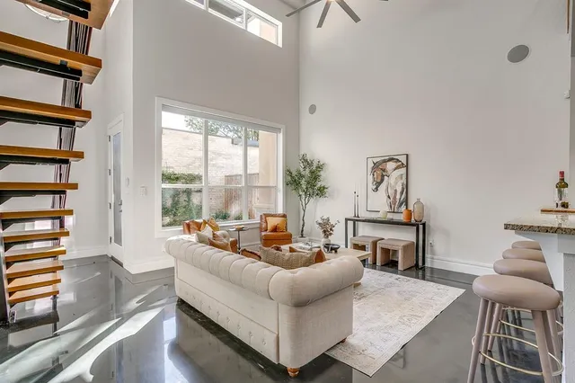 a living room with furniture and a floor to ceiling window