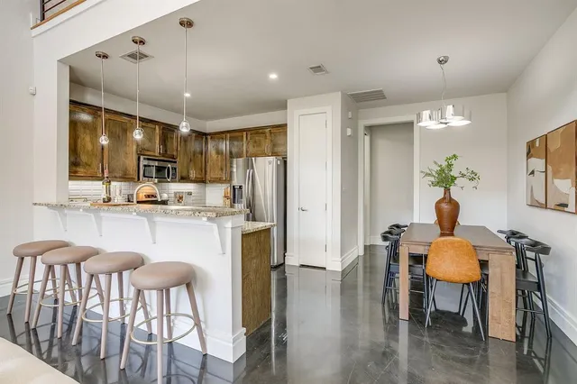 a kitchen with granite countertop counter space dining table and stainless steel appliances