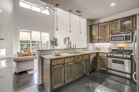 a kitchen that has a sink and a stove in it