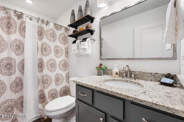 667 Turkey Nest Road Gatlinburg, TN 37738 - Photo 16 of 29 a bathroom with a granite countertop sink a toilet and a shower curtain