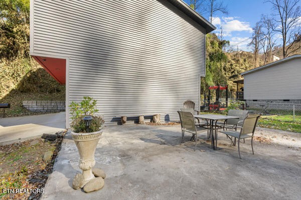 667 Turkey Nest Road Gatlinburg, TN 37738 - Photo 21 of 29 a view of a patio with table and chairs and potted plants