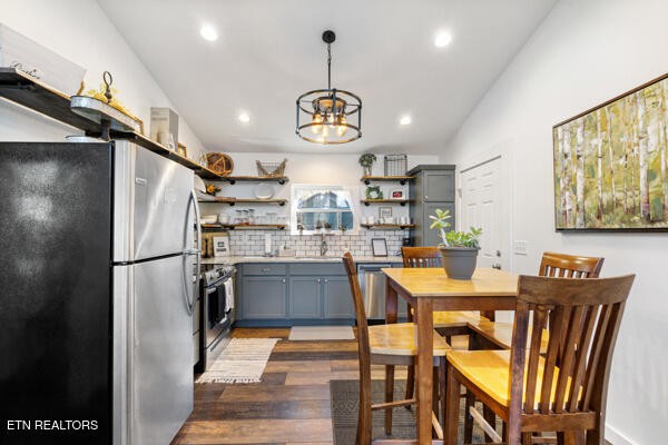 667 Turkey Nest Road Gatlinburg, TN 37738 - Photo 9 of 29 a kitchen with stainless steel appliances granite countertop a refrigerator a sink dishwasher a dining table and chairs with wooden floor