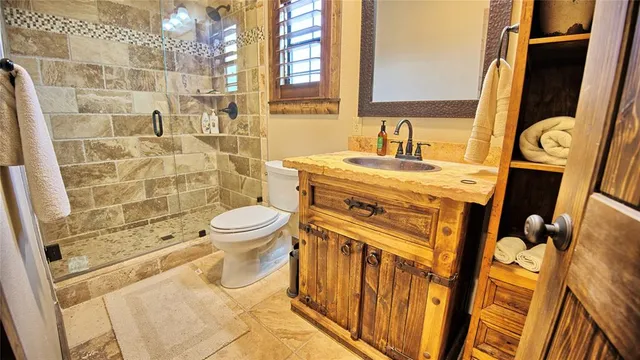 a bathroom with a sink toilet and shower