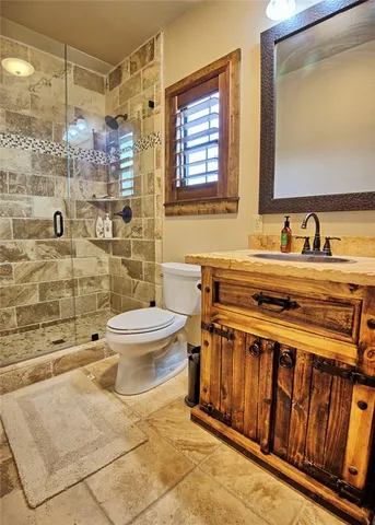 a bathroom with a sink toilet and shower