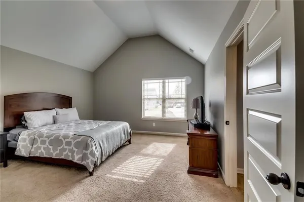 a bed room with furniture and a flat screen tv