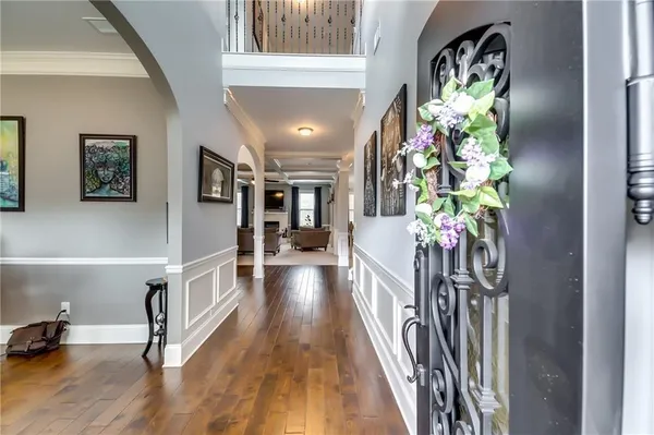 a view of a hallway with wooden floor and stairs