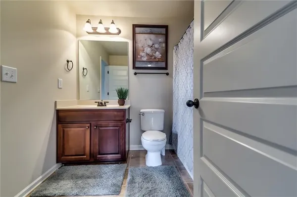 a spacious bathroom with a toilet a sink and bathtub