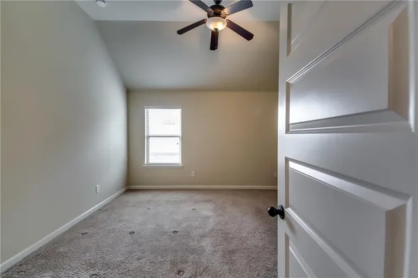 an empty room with closet and natural light