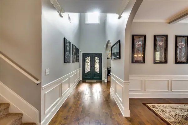 a view of a hallway with wooden floor and staircase