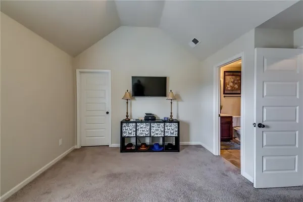 a view of empty room with closet and fireplace