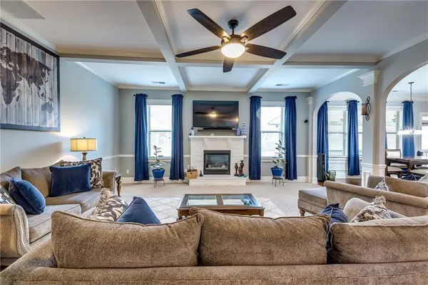 a living room with fireplace furniture and a large window