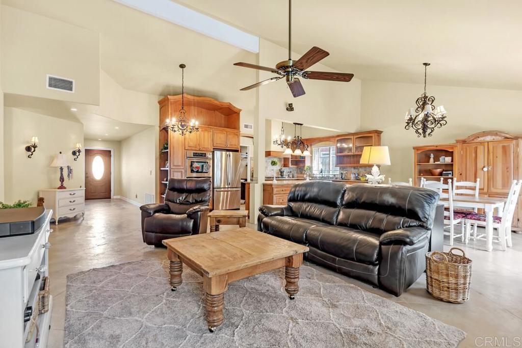 10447 Cadwell Road Santee, CA 92071 - Photo 11 of 32 a living room with furniture a chandelier and a flat screen tv