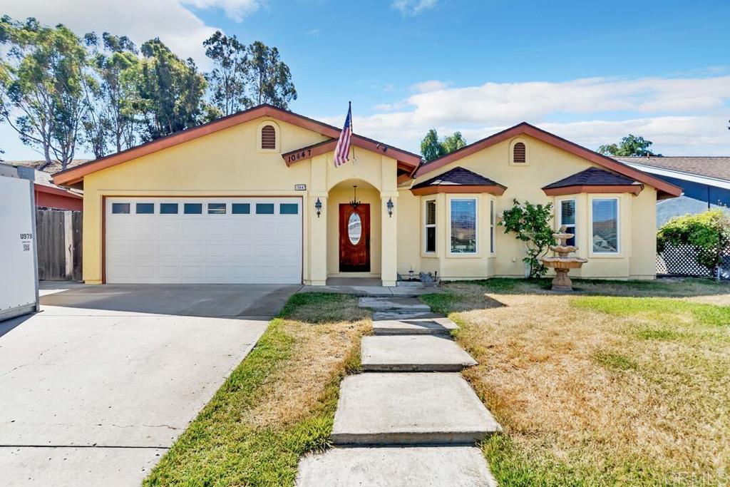 10447 Cadwell Road Santee, CA 92071 - Photo 3 of 32 a front view of a house with a yard and garage