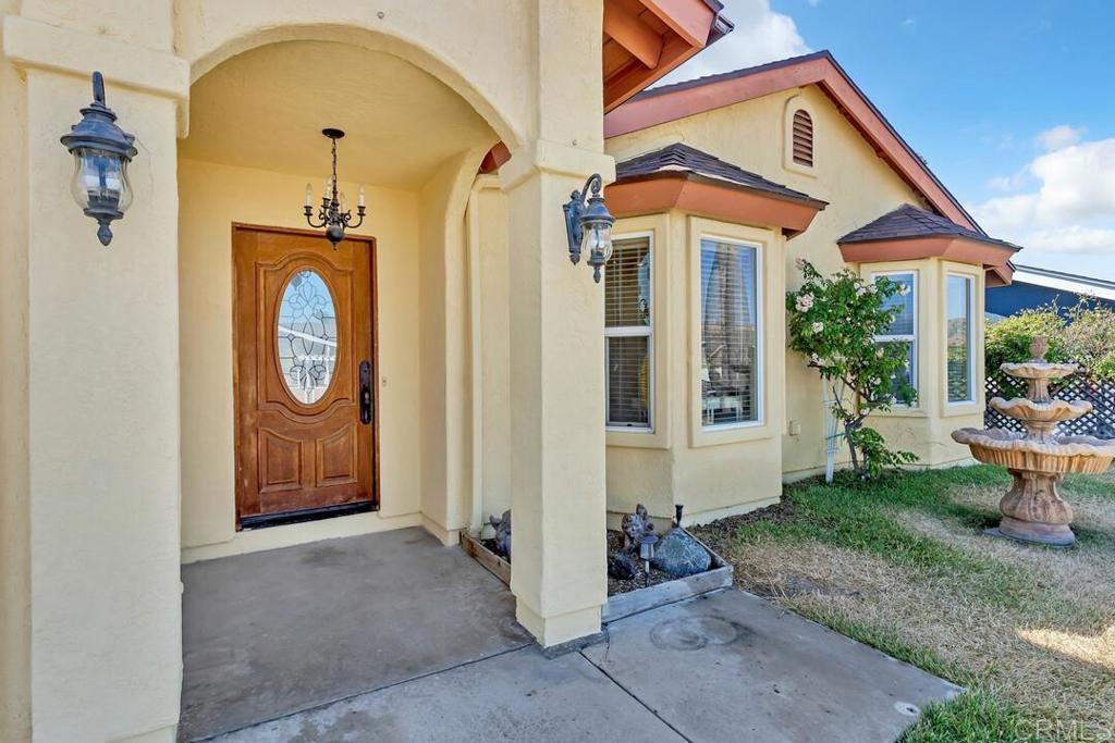 10447 Cadwell Road Santee, CA 92071 - Photo 4 of 32 a front view of a house with garden