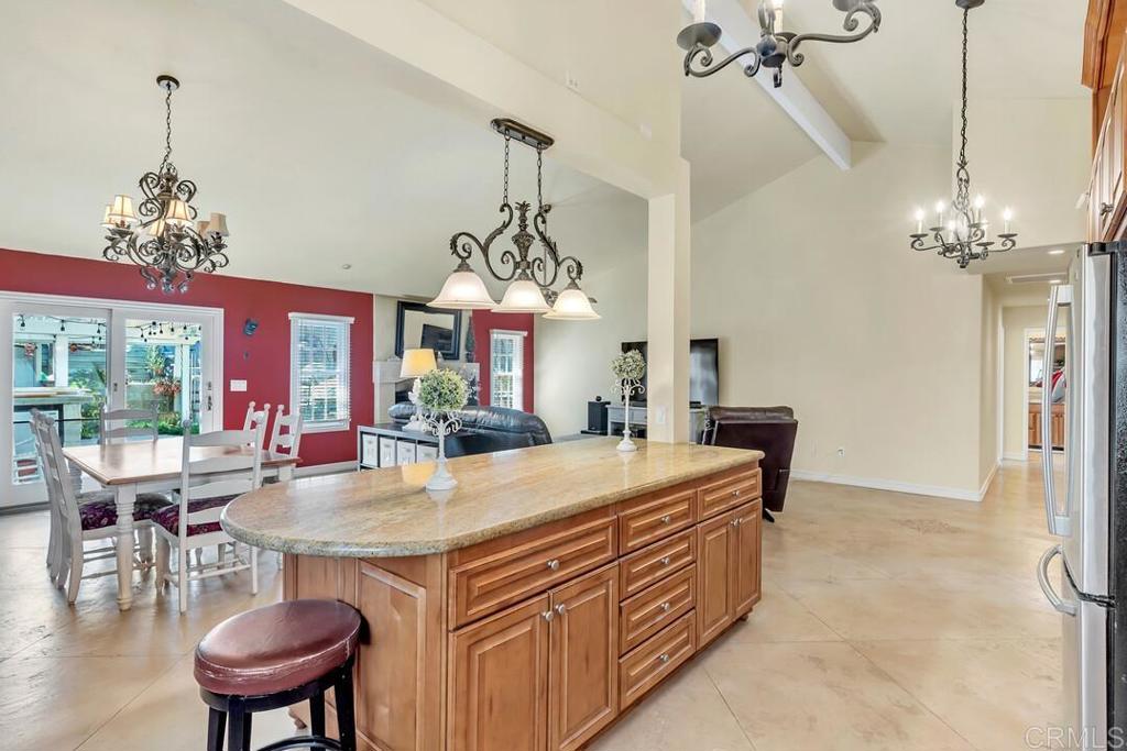 10447 Cadwell Road Santee, CA 92071 - Photo 8 of 32 a view of a dining room with furniture a chandelier and wooden floor