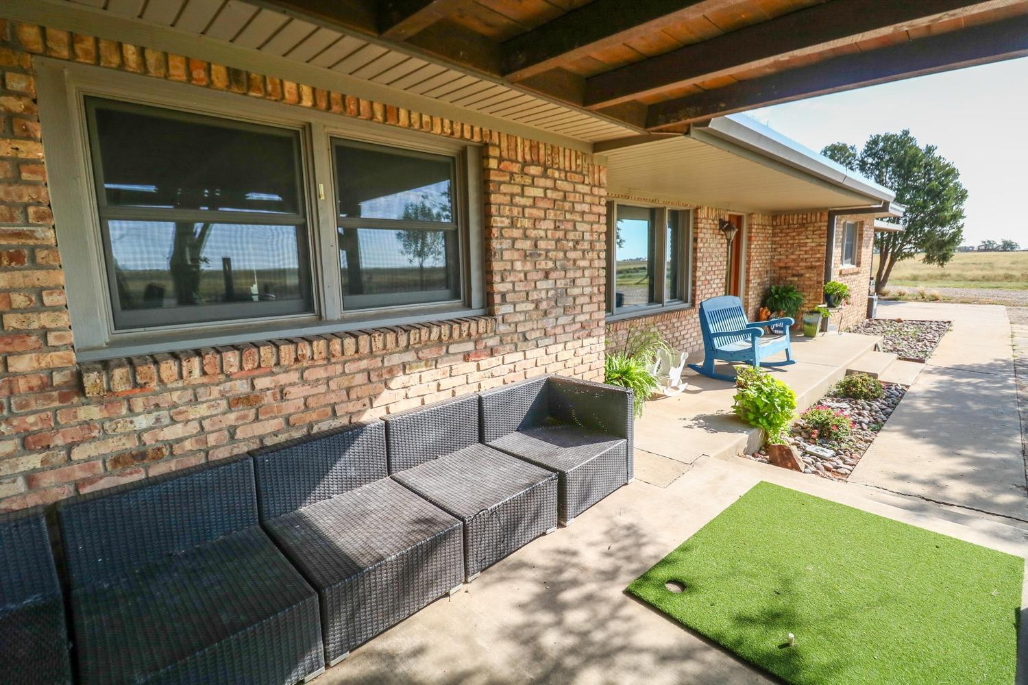 311 County Road 74 Muleshoe, TX 79347 - Photo 24 of 39 a view of a patio with couches table and chairs and potted plants
