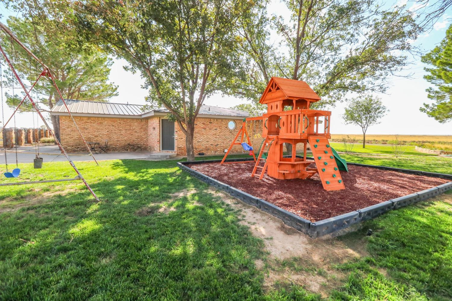 311 County Road 74 Muleshoe, TX 79347 - Photo 28 of 39 a front view of a house with a yard garden and outdoor seating