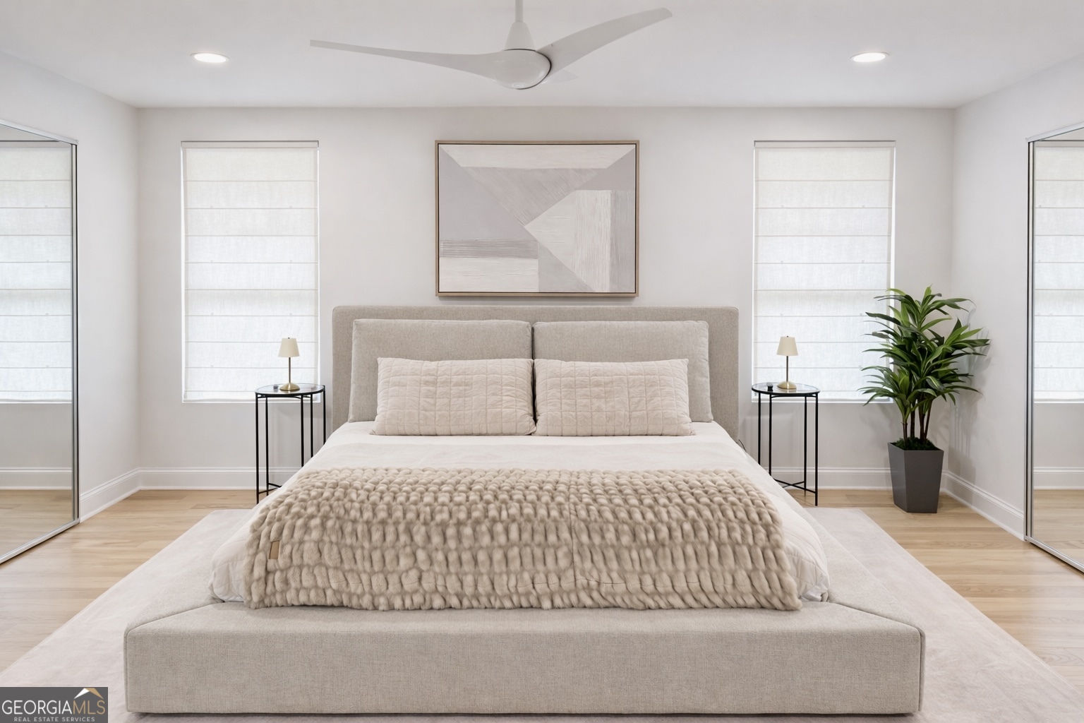 3045 Hitt Road Cumming, GA 30041 - Photo 11 of 46 a bedroom with a large bed and a potted plant