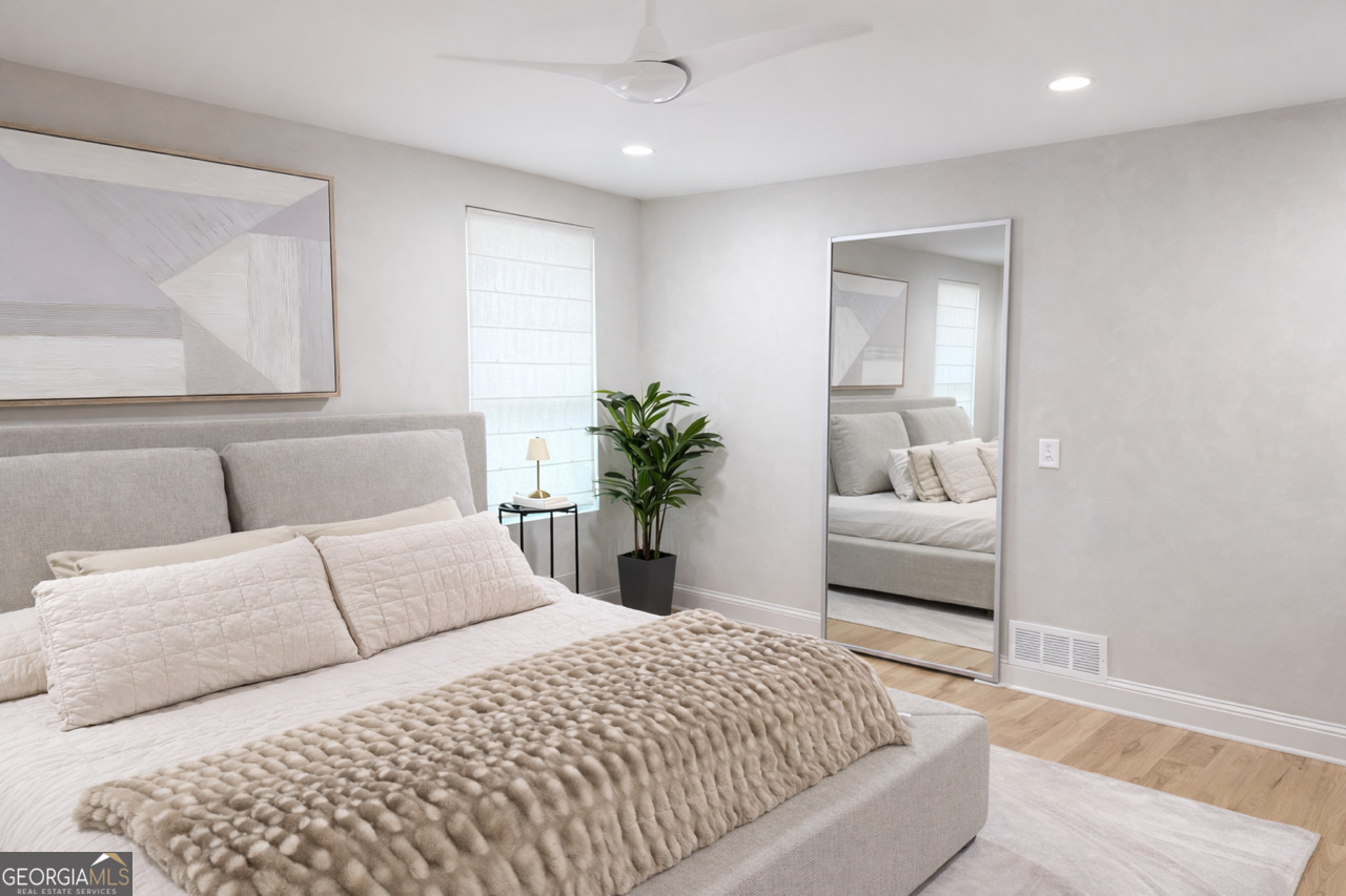 3045 Hitt Road Cumming, GA 30041 - Photo 12 of 46 a bedroom with a bed and a couch