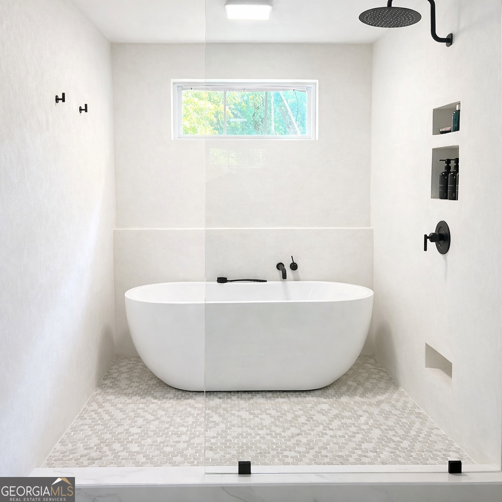 3045 Hitt Road Cumming, GA 30041 - Photo 14 of 46 a white tub sitting next to a window