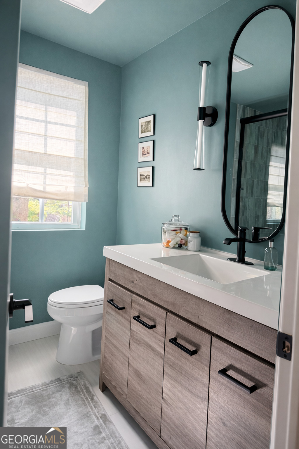 3045 Hitt Road Cumming, GA 30041 - Photo 20 of 46 a bathroom with a toilet a sink and mirror